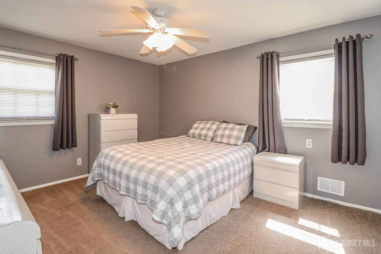 26 Moryan Road Edison, NJ 08817 - Photo 17 of 32 a bedroom with a bed table and two window