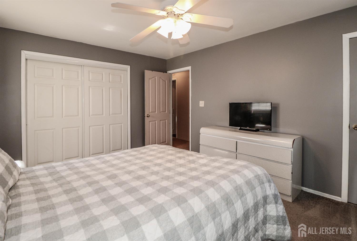 26 Moryan Road Edison, NJ 08817 - Photo 18 of 32 a bedroom with a bed and a flat screen tv