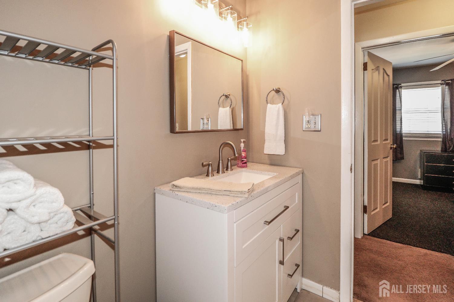 26 Moryan Road Edison, NJ 08817 - Photo 22 of 32 a en suite bathroom with a sink and a mirror