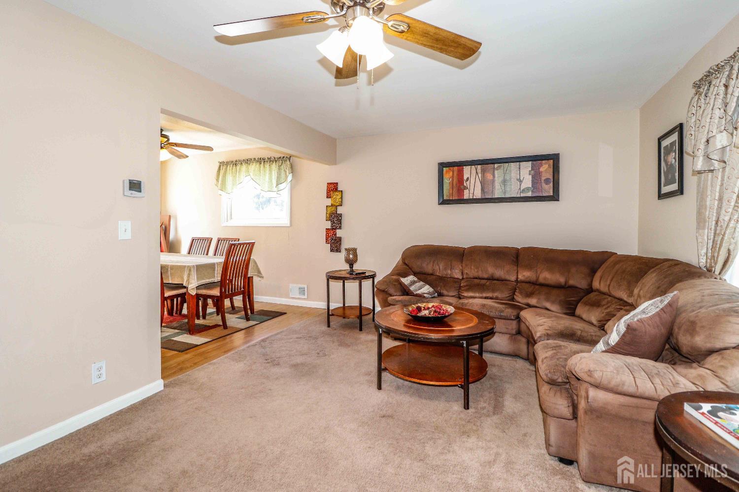 26 Moryan Road Edison, NJ 08817 - Photo 8 of 32 a living room with furniture and a chandelier