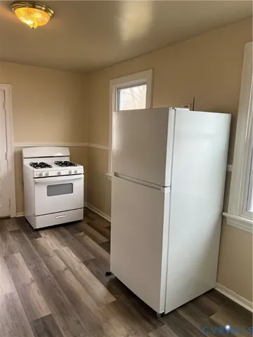 a kitchen with a refrigerator and a stove