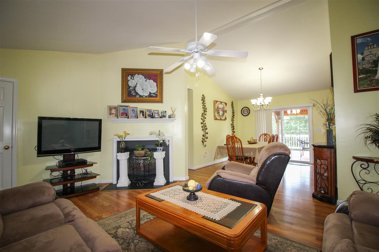 5146 Amicus Road Ruckersville, VA 22968 - Photo 8 of 23 a living room with fireplace furniture and a flat screen tv