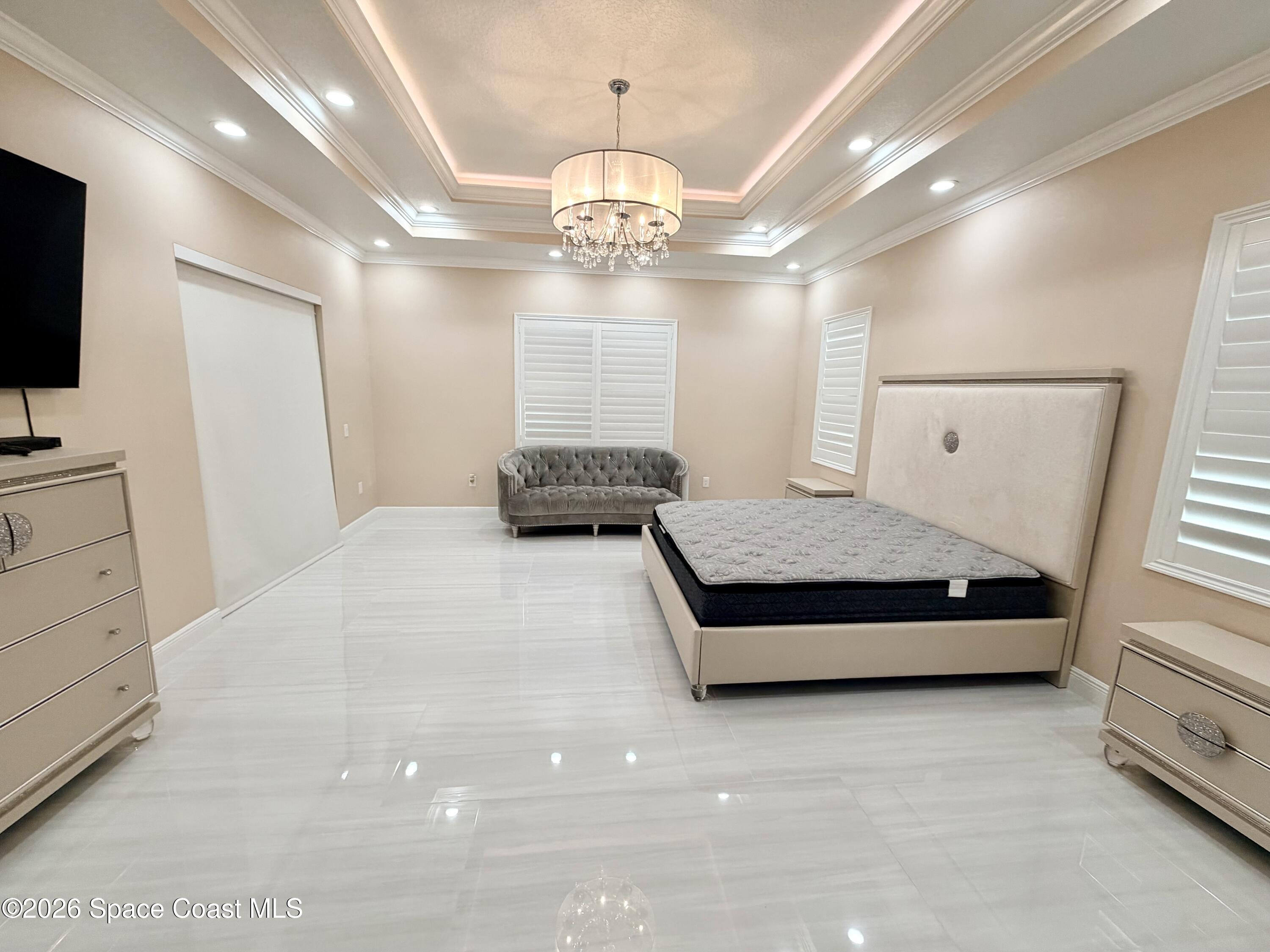 369 Tolley Avenue Melbourne, FL 32934 - Photo 13 of 33 a bedroom with a bed window and flat screen tv
