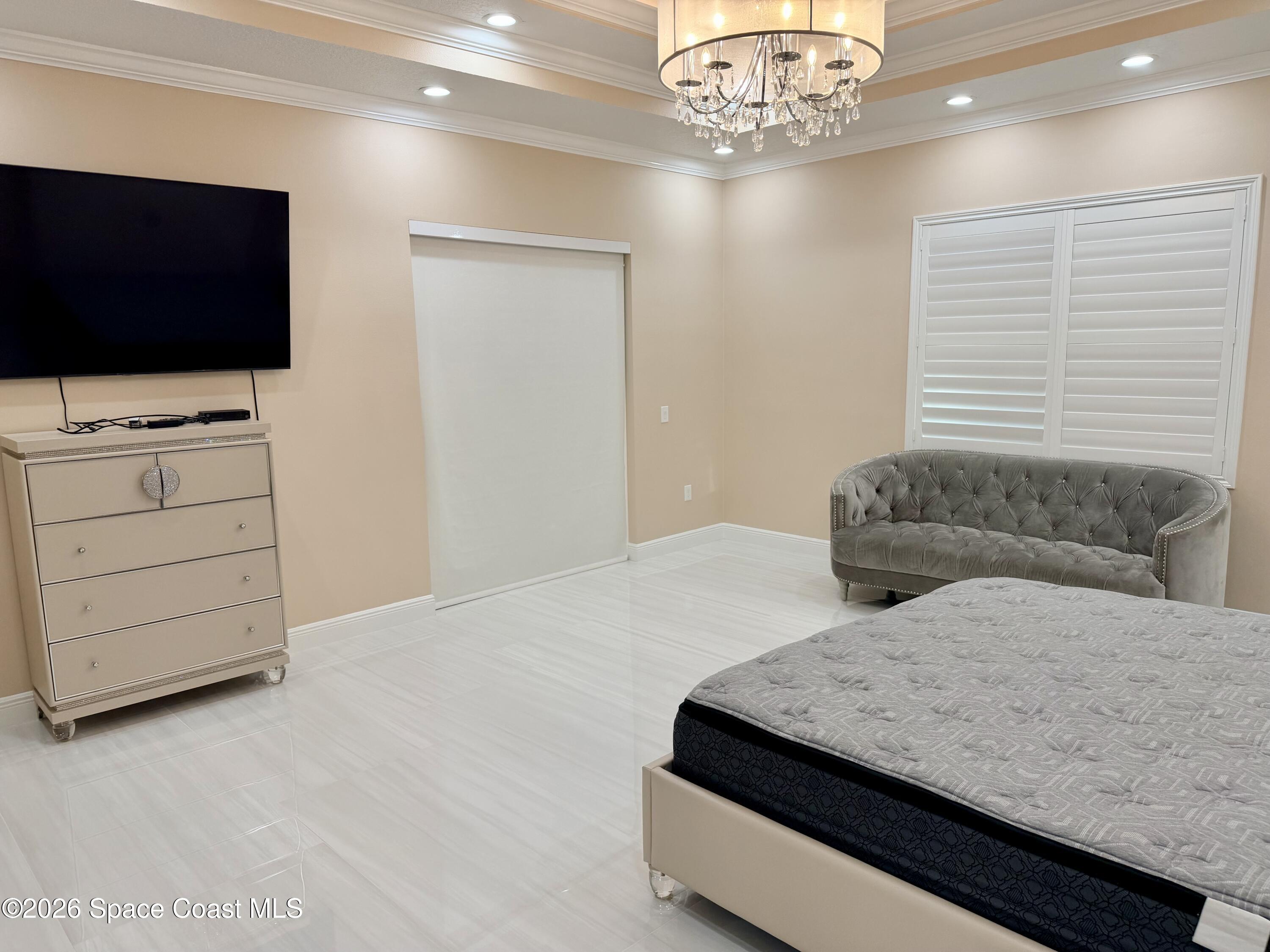 369 Tolley Avenue Melbourne, FL 32934 - Photo 16 of 33 a bedroom with bed and flat screen tv