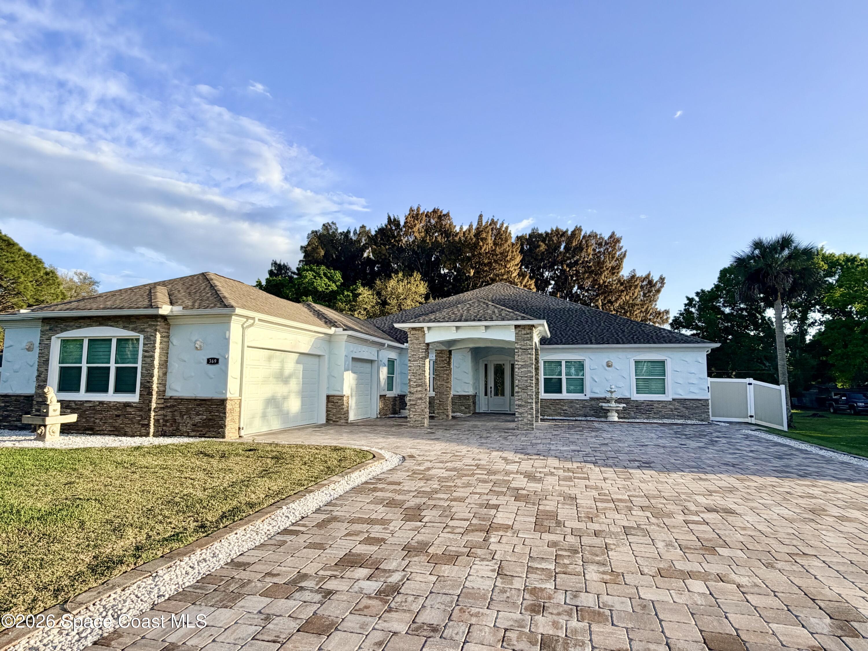 369 Tolley Avenue Melbourne, FL 32934 - Photo 2 of 33 a front view of a house with a yard and potted plants