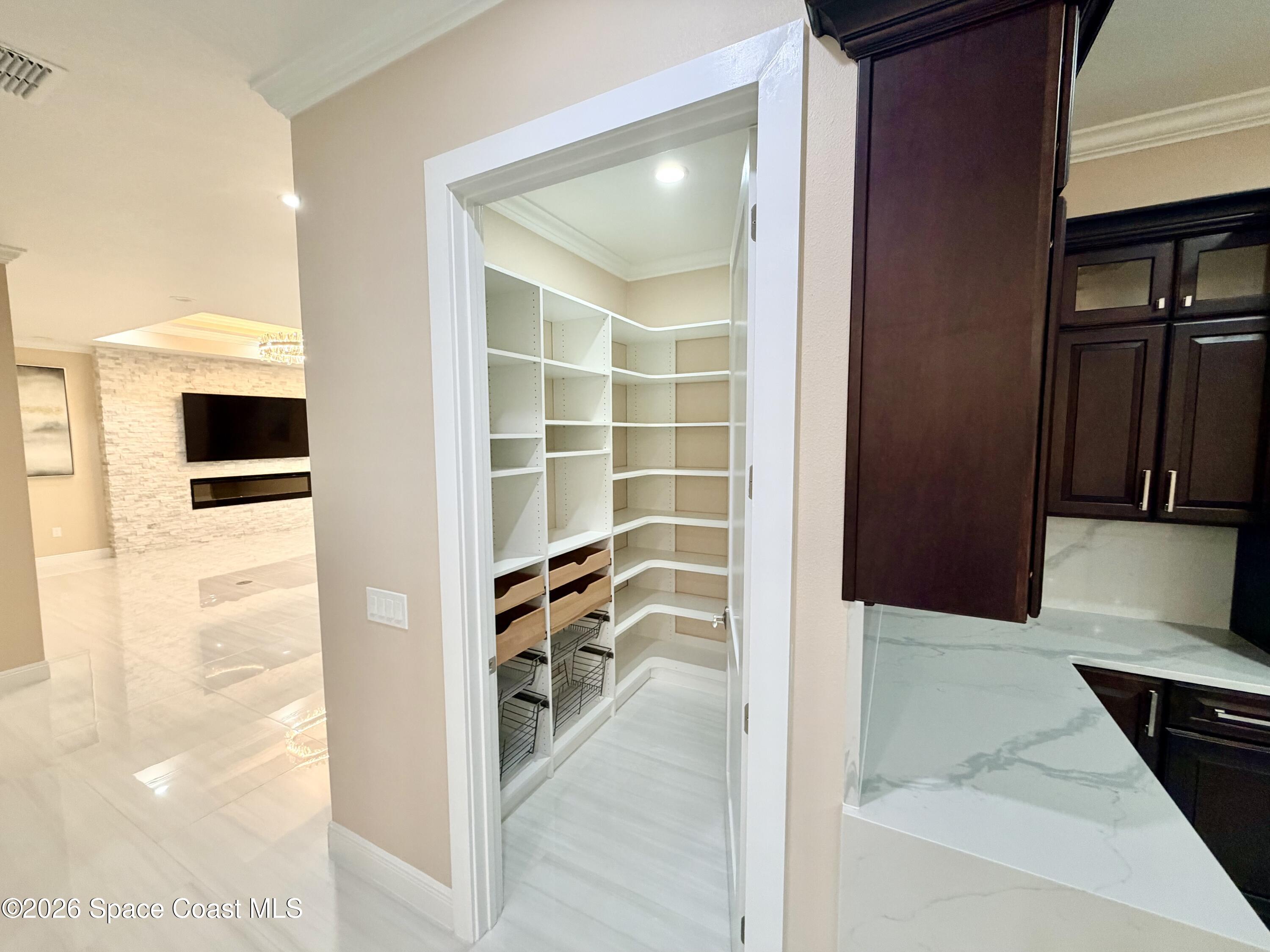 369 Tolley Avenue Melbourne, FL 32934 - Photo 21 of 33 a view of a hallway with wooden floor and living room