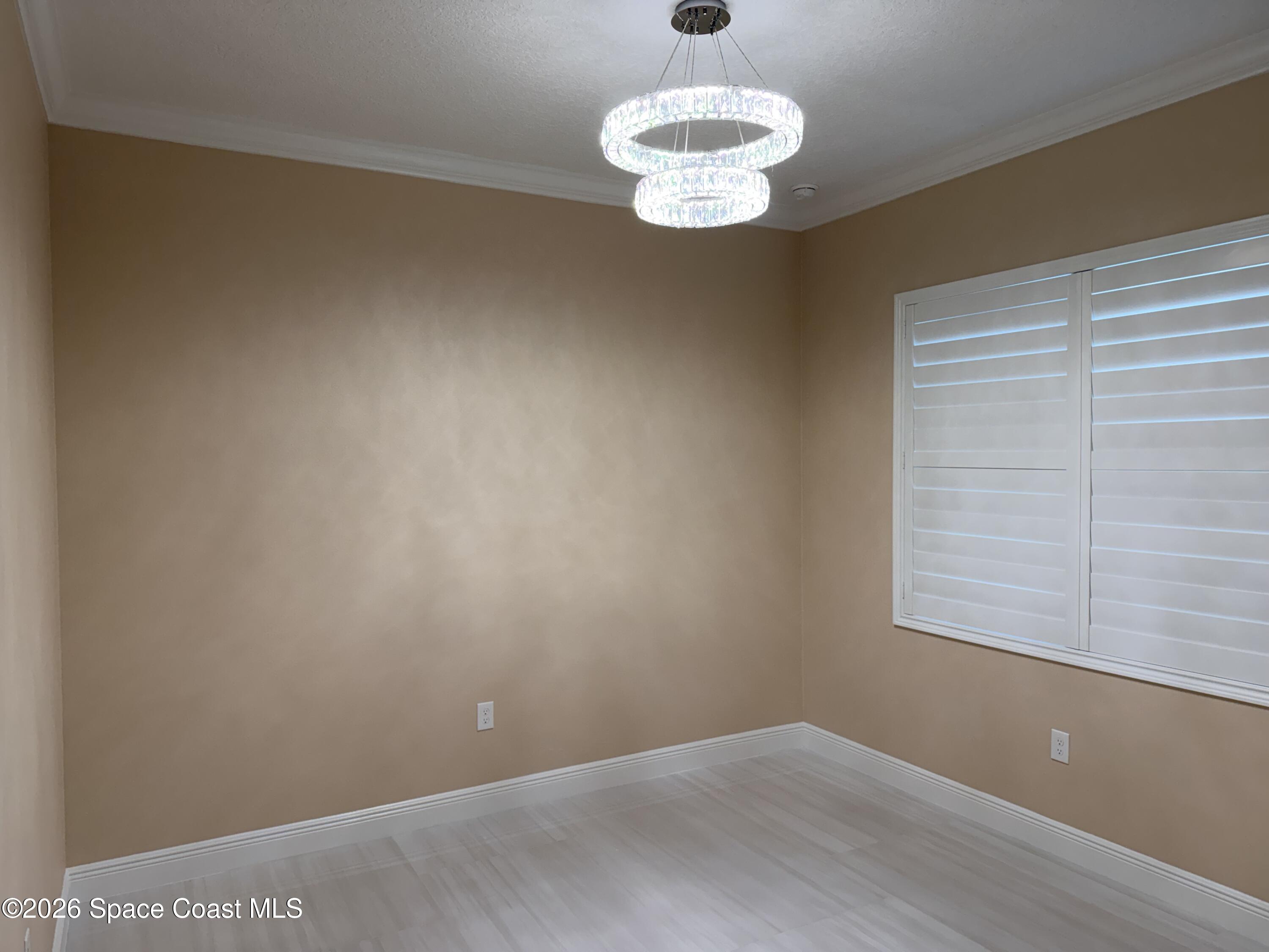 369 Tolley Avenue Melbourne, FL 32934 - Photo 23 of 33 a view of an empty room with a window