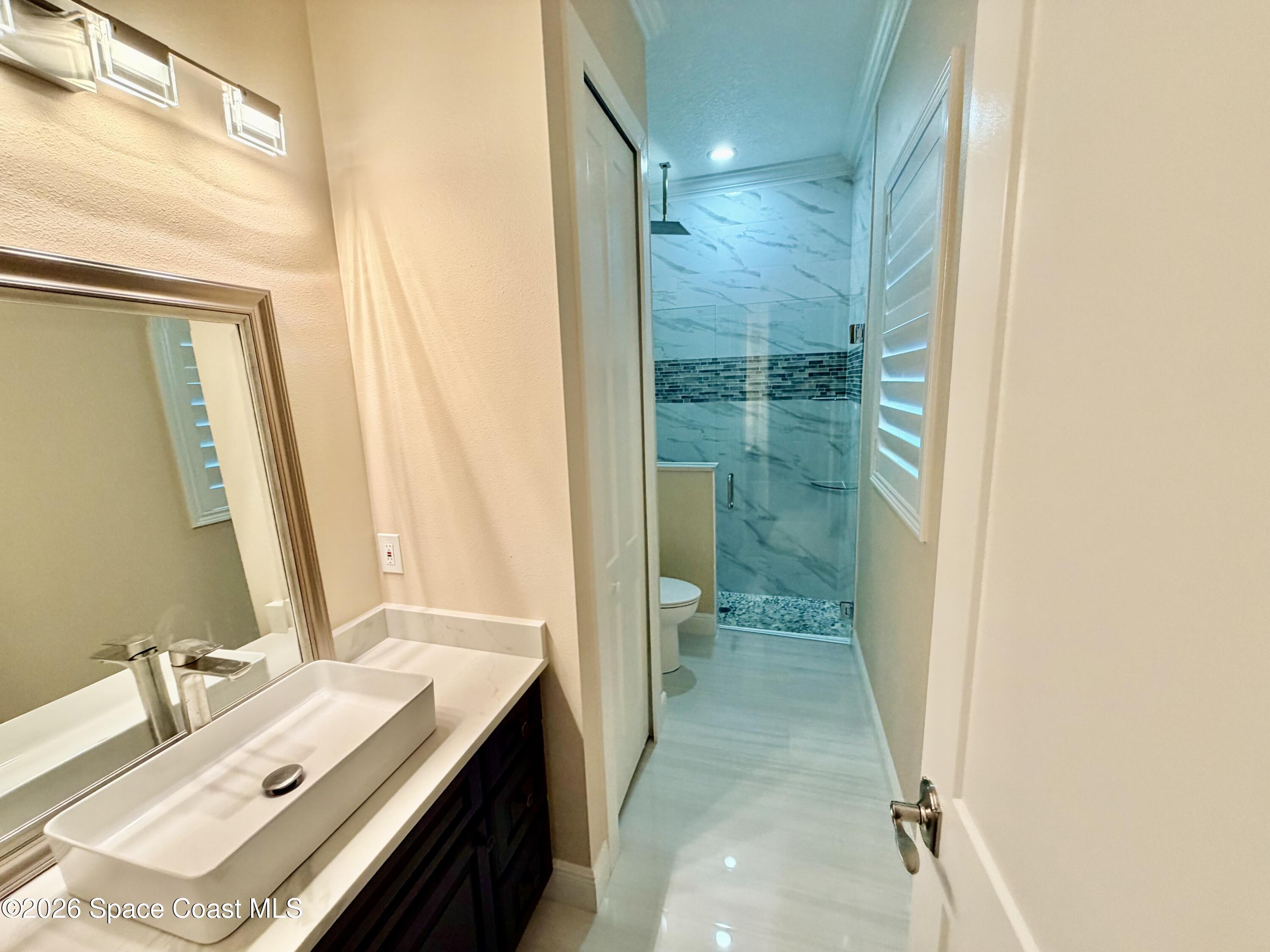 369 Tolley Avenue Melbourne, FL 32934 - Photo 29 of 33 a bathroom with a sink and a mirror