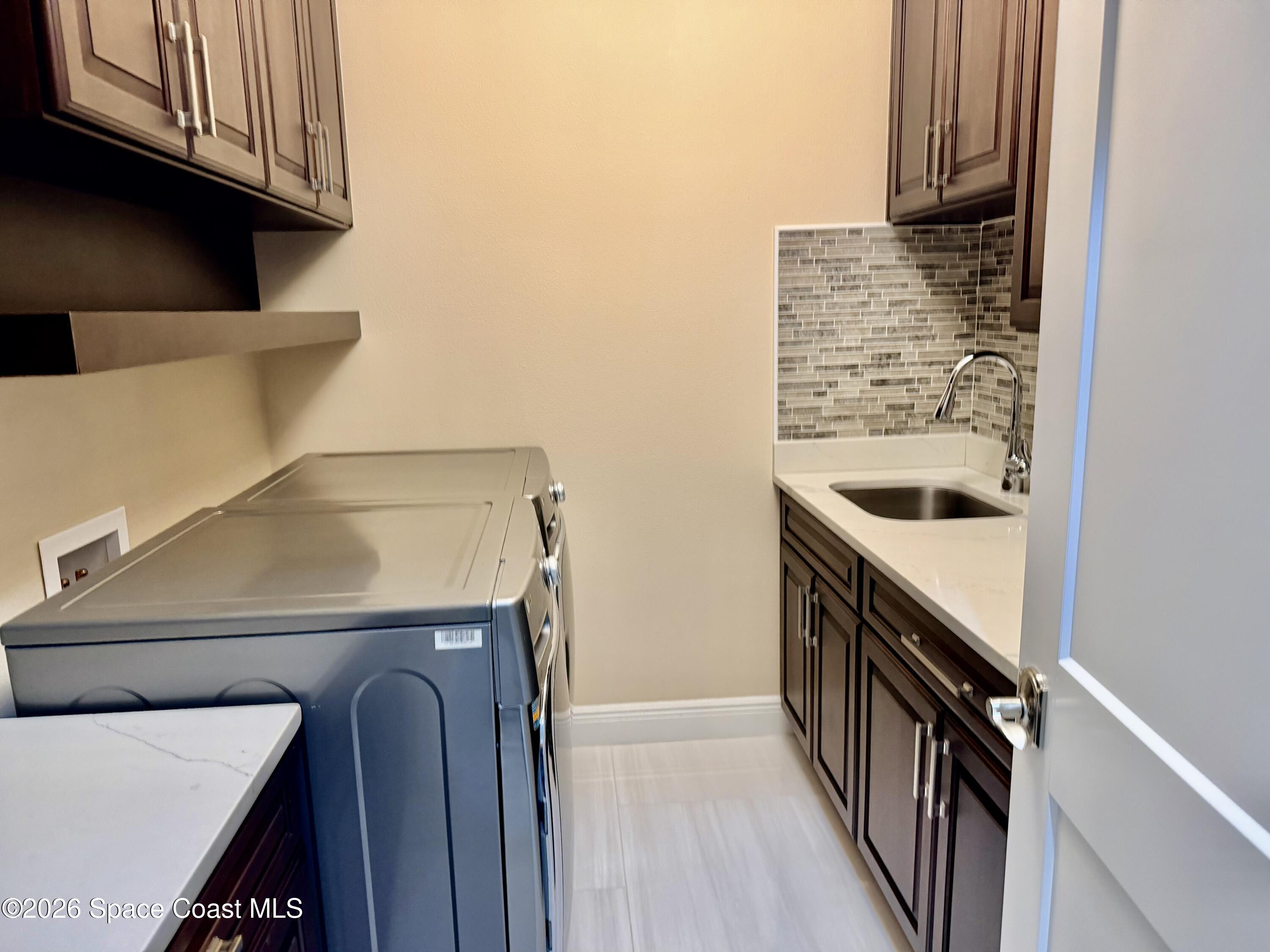 369 Tolley Avenue Melbourne, FL 32934 - Photo 31 of 33 a utility room with dryer and washer