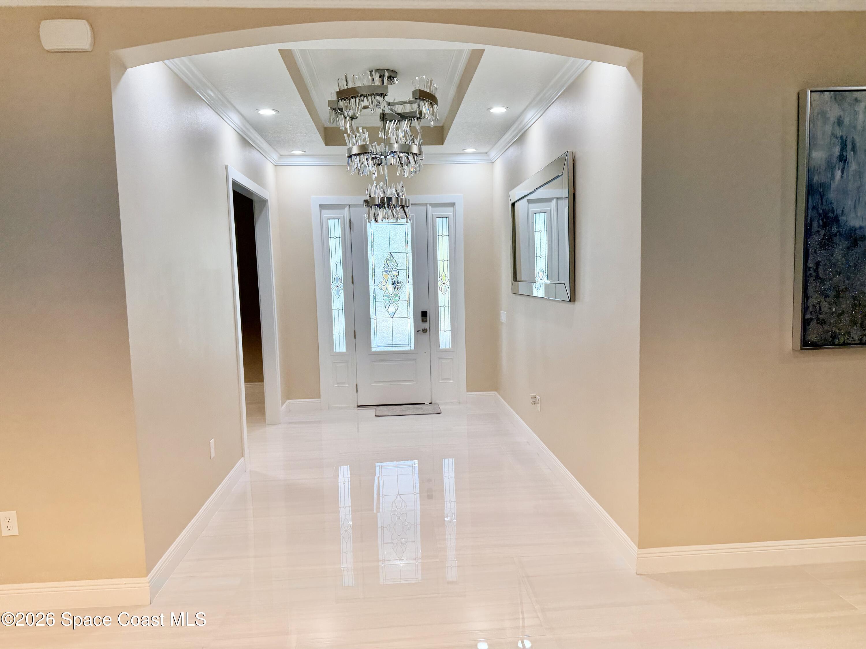 369 Tolley Avenue Melbourne, FL 32934 - Photo 4 of 33 a view of a hallway with a chandelier
