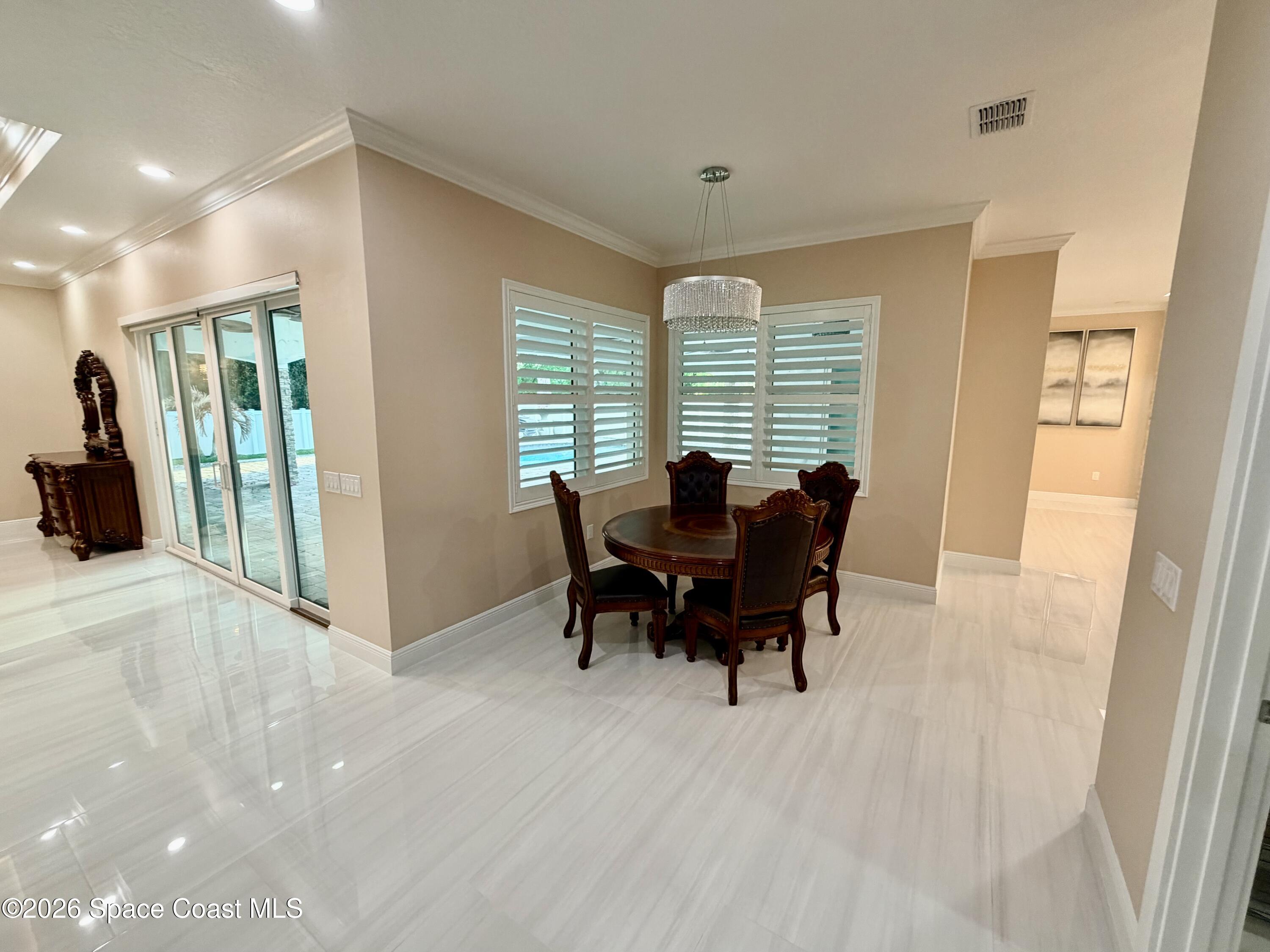 369 Tolley Avenue Melbourne, FL 32934 - Photo 7 of 33 a dining room with furniture and window