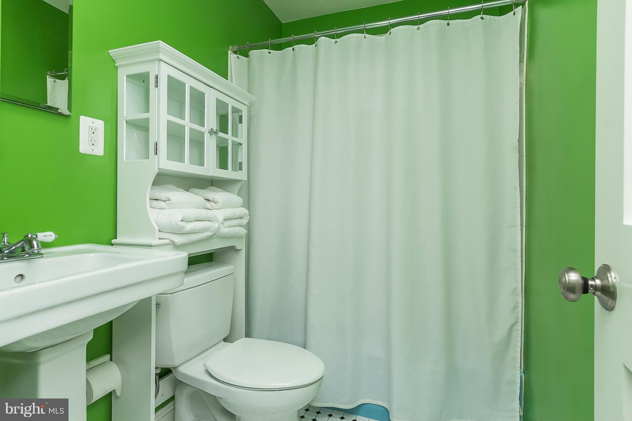 1908 Fairbank Road Baltimore, MD 21209 - Photo 17 of 27 a bathroom with a toilet a sink and curtain