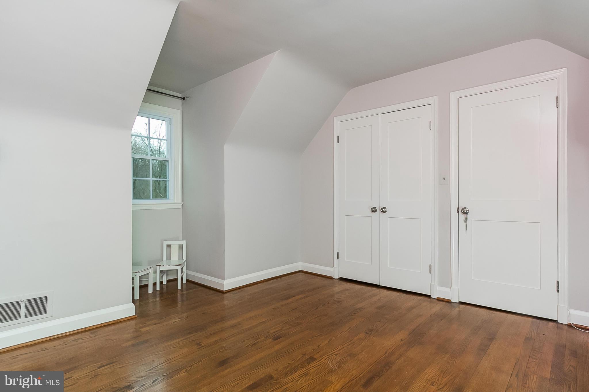 1908 Fairbank Road Baltimore, MD 21209 - Photo 19 of 27 an empty room with wooden floor and windows