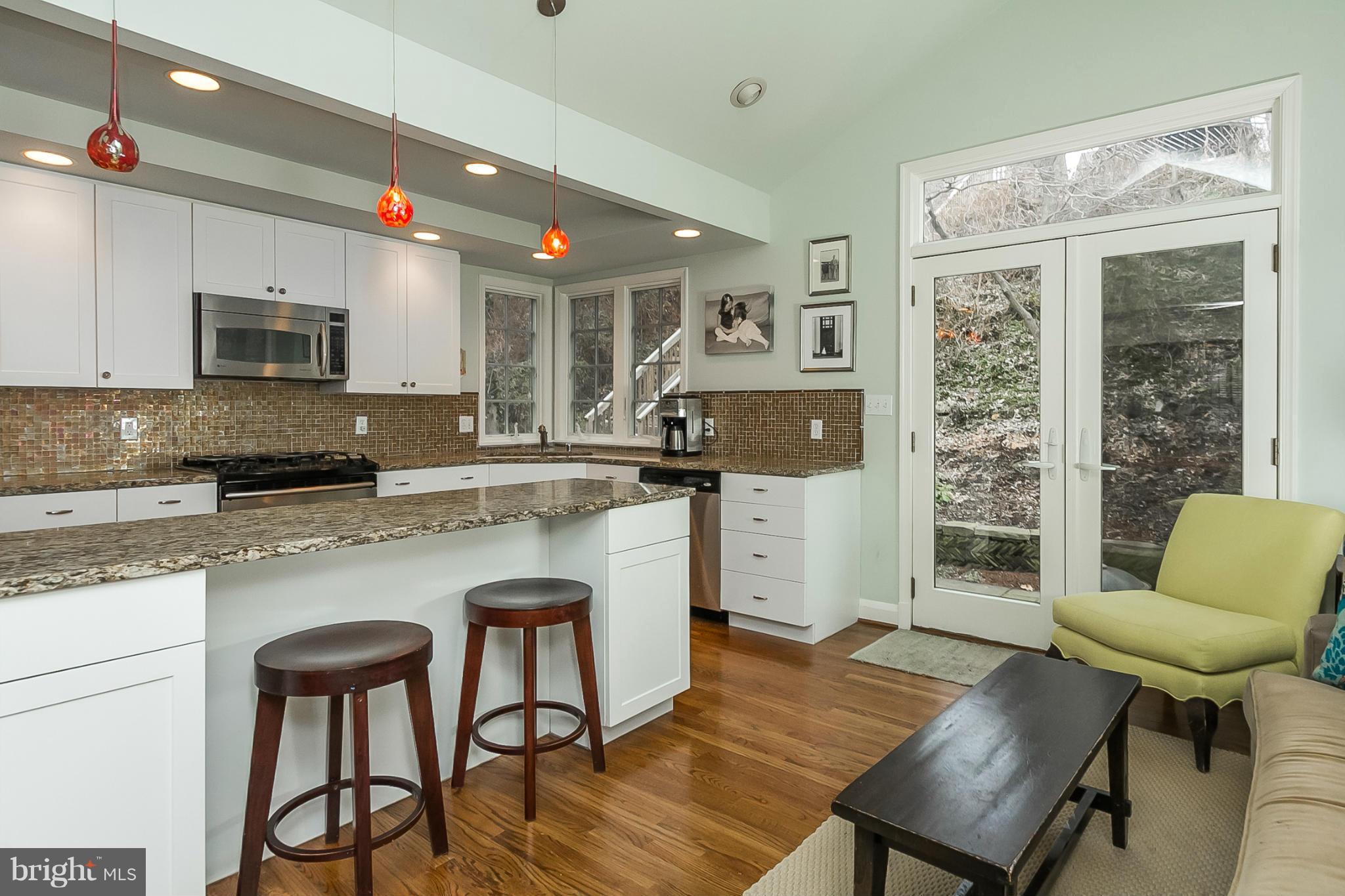 1908 Fairbank Road Baltimore, MD 21209 - Photo 9 of 27 a kitchen with stainless steel appliances granite countertop a stove a refrigerator a microwave a dining table and chairs