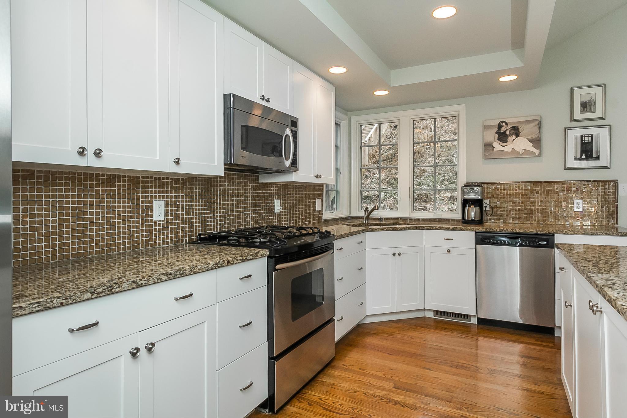 1908 Fairbank Road Baltimore, MD 21209 - Photo 10 of 27 a kitchen with stainless steel appliances granite countertop a stove sink and microwave