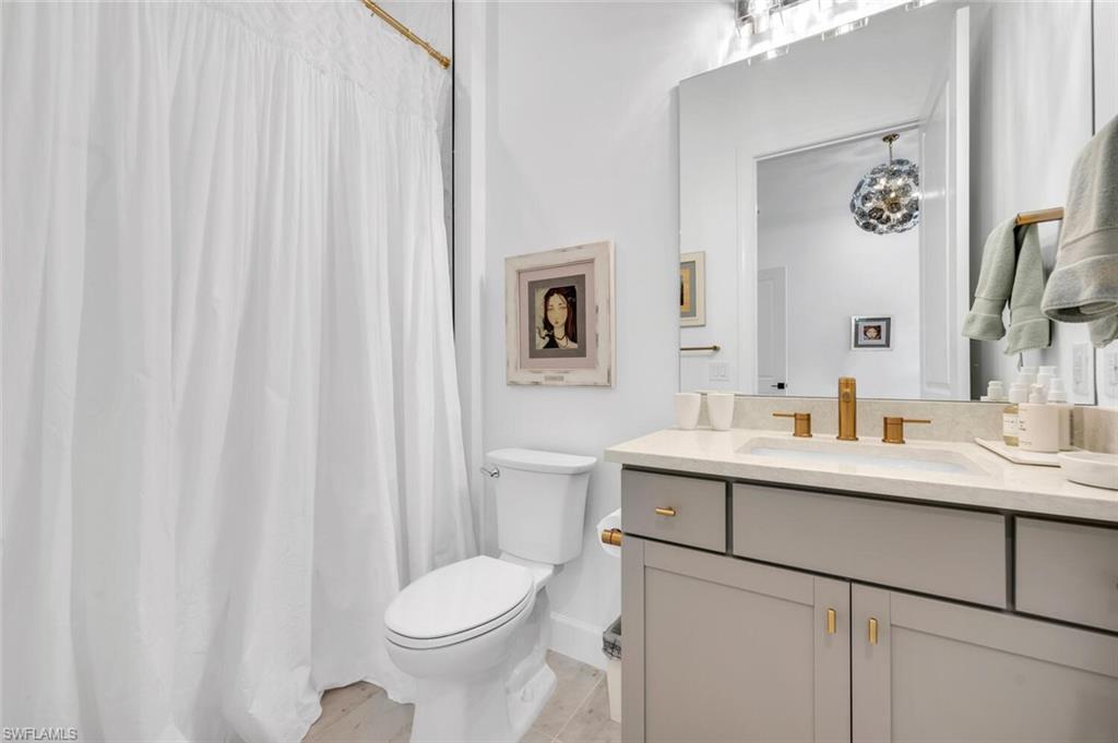 20557 Napa Loop Estero, FL 33928 - Photo 18 of 23 a bathroom with a toilet sink and mirror