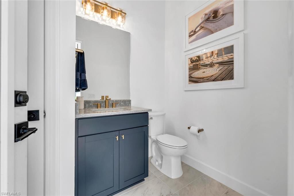 20557 Napa Loop Estero, FL 33928 - Photo 22 of 23 a bathroom with a toilet sink and mirror