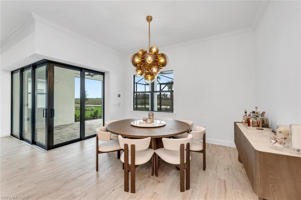 20557 Napa Loop Estero, FL 33928 - Photo 7 of 23 a dining room with furniture a chandelier and wooden floor