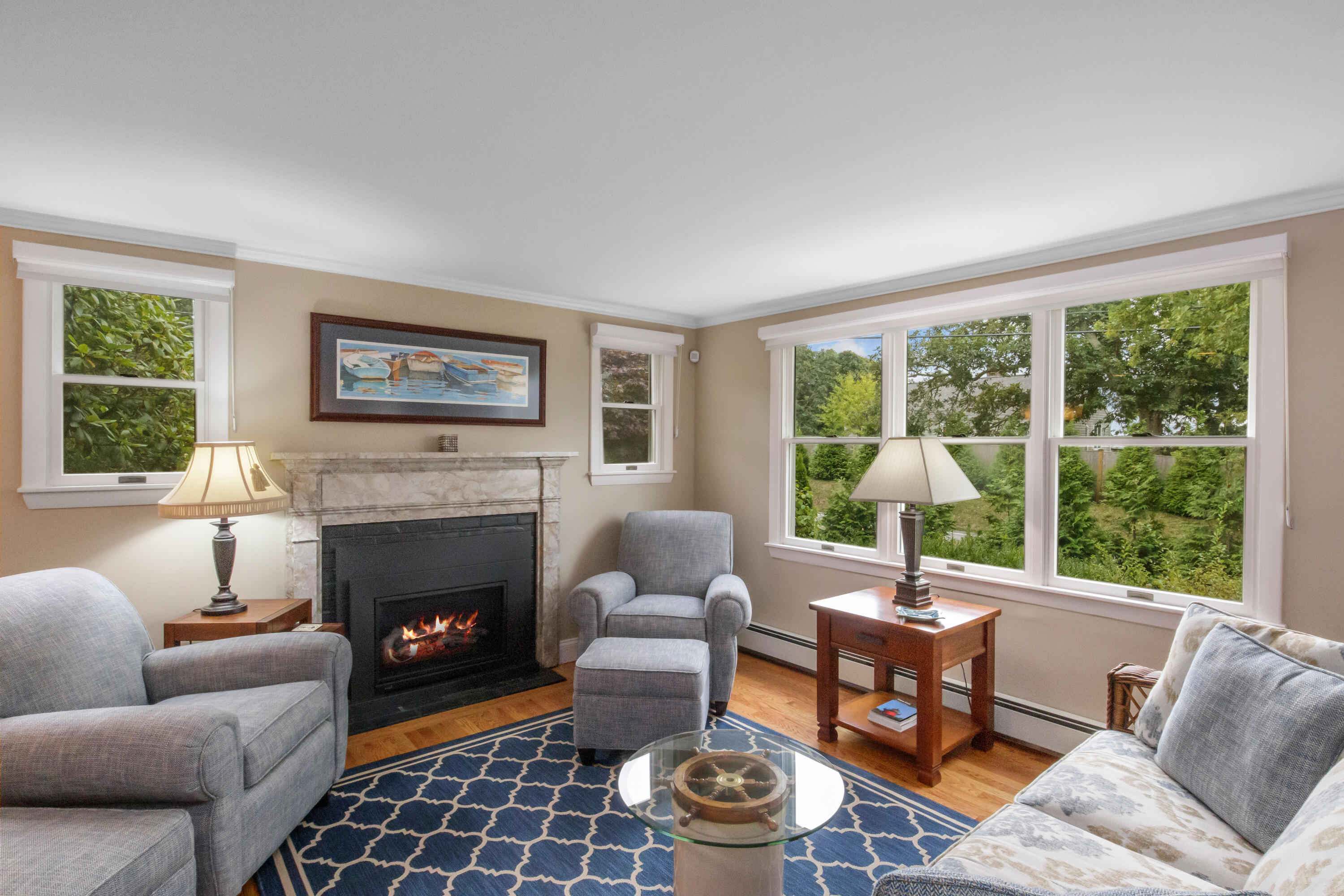306 Old Queen Anne Road Chatham, MA 02633 - Photo 9 of 41 a living room with furniture a fireplace and a large window