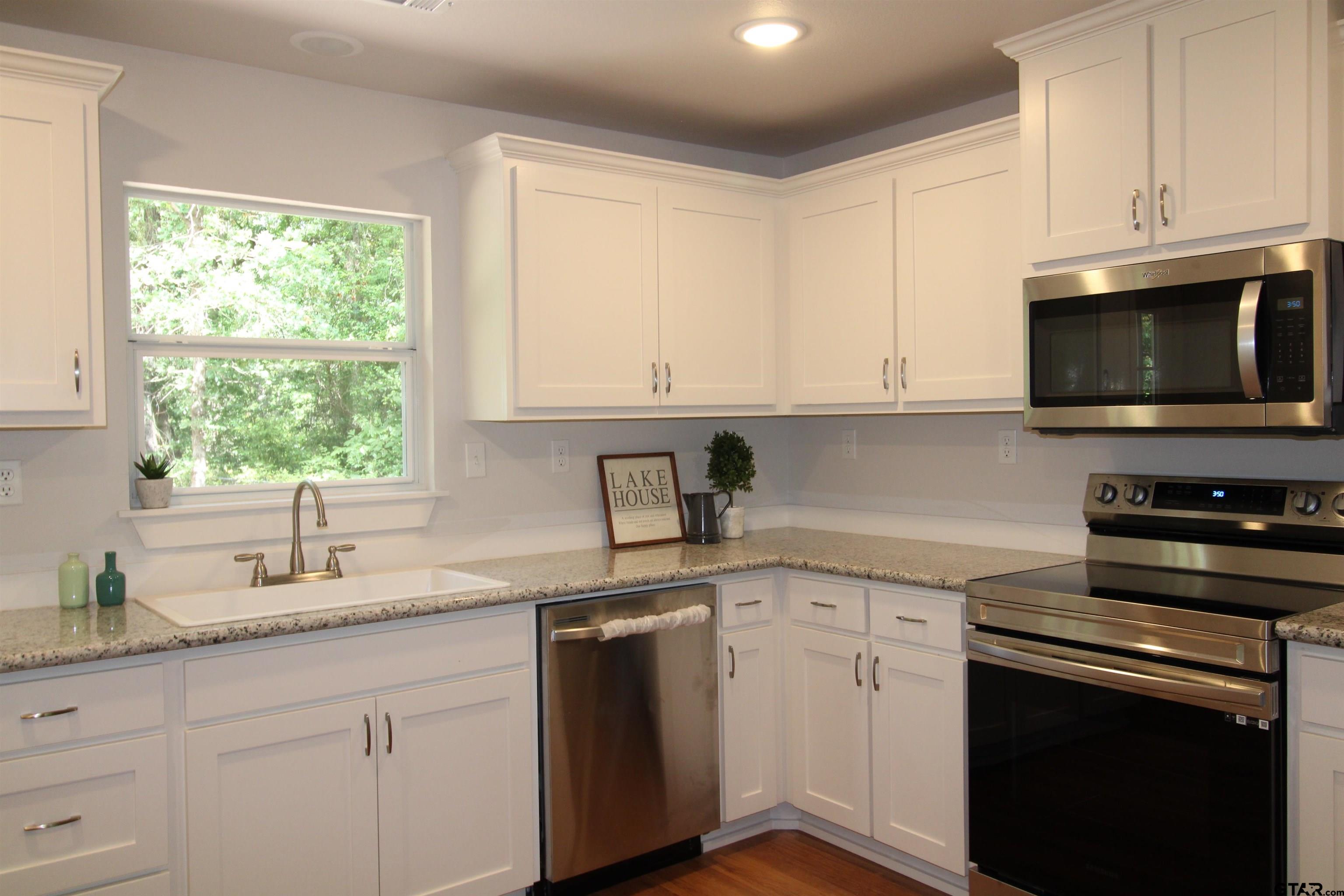 136 Long Shadow Drive Murchison, TX 75778 - Photo 12 of 19 a kitchen with cabinets appliances a sink and a window