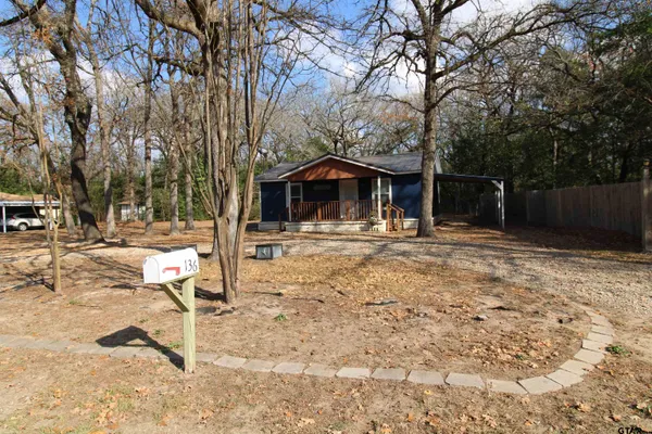 a view of house with yard and trees