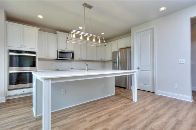 a view of kitchen with granite countertop cabinets and steel stainless steel appliances