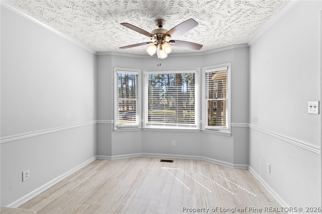 7756 Dragonhead Road Fayetteville, NC 28311 - Photo 10 of 42 an empty room with a ceiling fan and window
