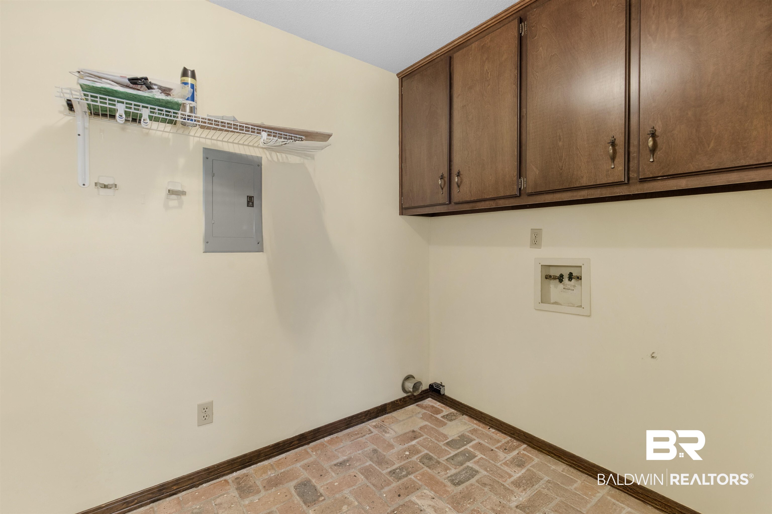 9215 Shiloh Drive Mobile, AL 36695 - Photo 28 of 32 Laundry area featuring brick flooring, electric panel, hookup for a washing machine, and cabinet space
