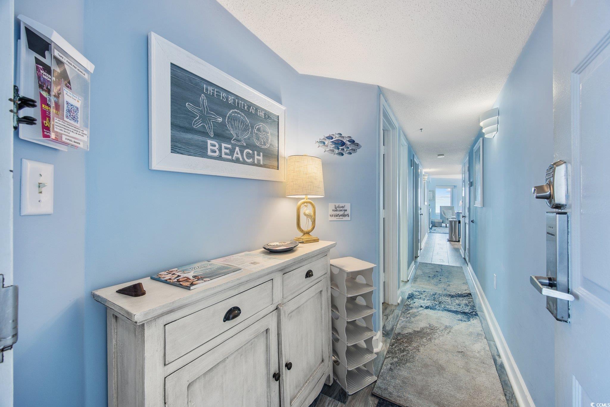 161 Seawatch Drive, Unit 1117 Myrtle Beach, SC 29572 - Photo 20 of 33 Hall featuring a textured ceiling and dark colored