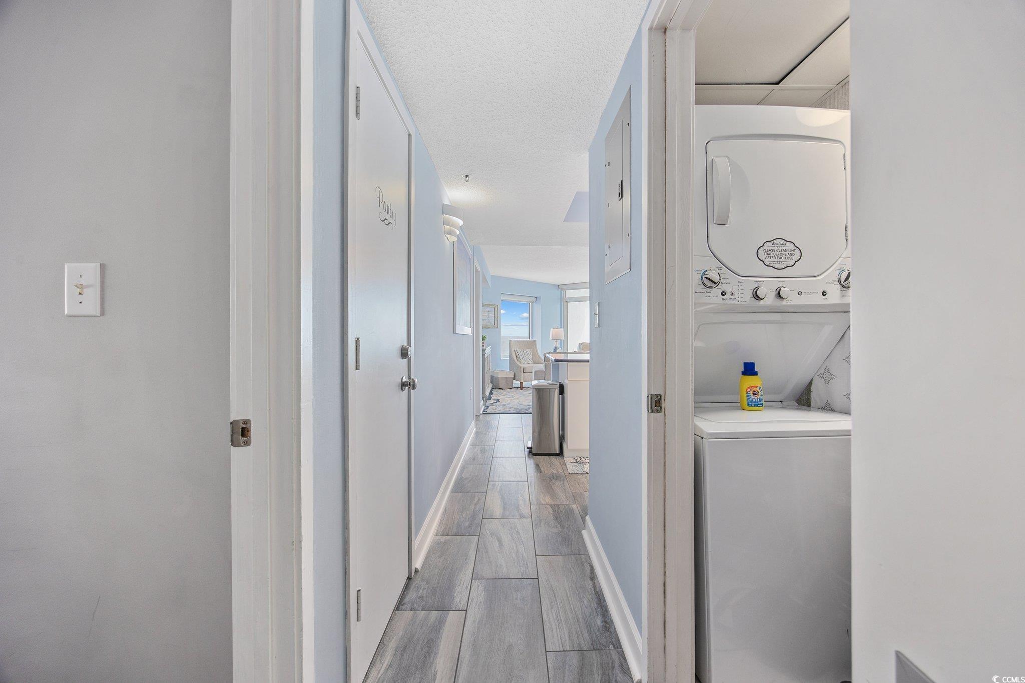 161 Seawatch Drive, Unit 1117 Myrtle Beach, SC 29572 - Photo 28 of 33 Hallway with wood tiled floors, estacked washer an