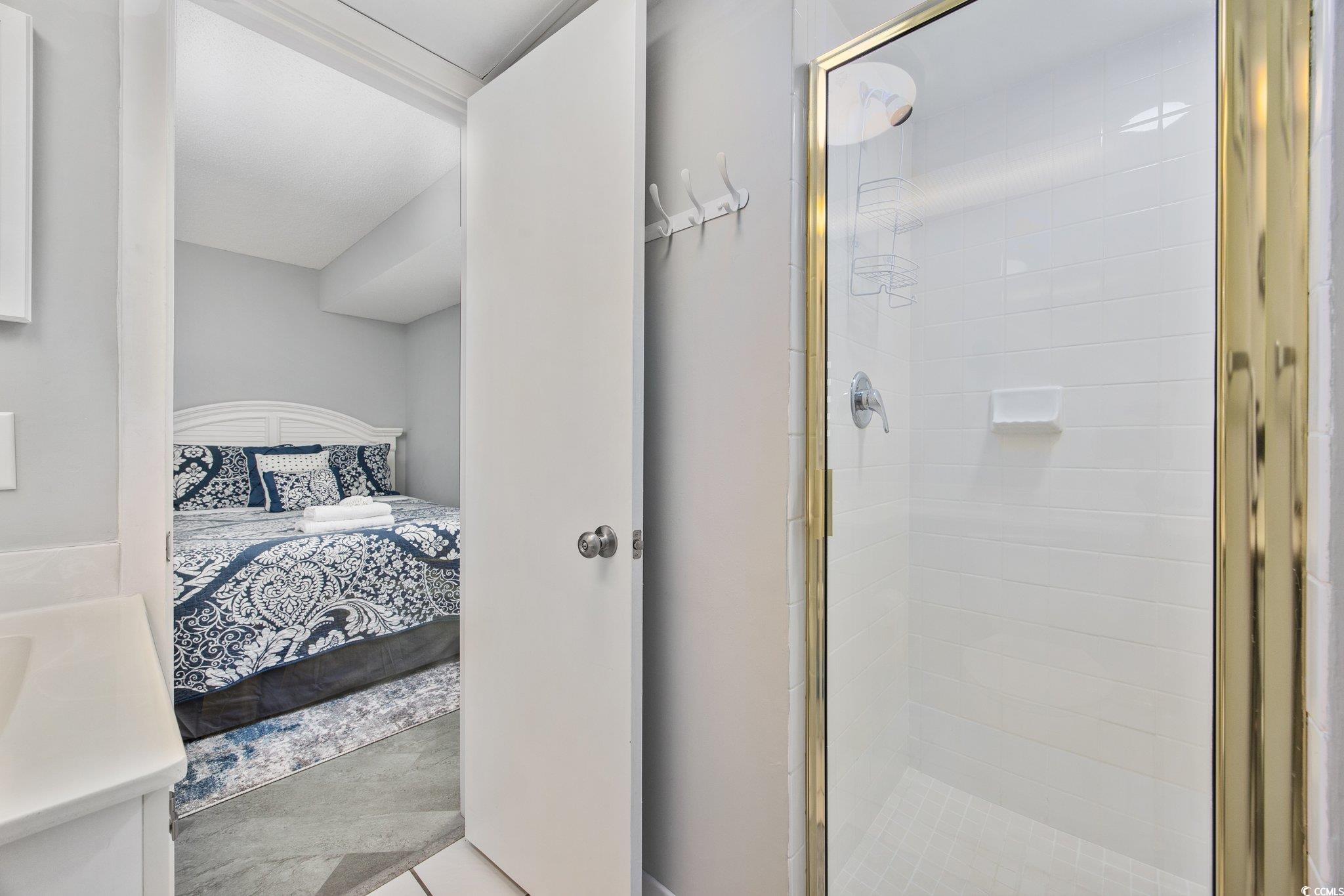 161 Seawatch Drive, Unit 1117 Myrtle Beach, SC 29572 - Photo 30 of 33 Ensuite bathroom with a stall shower, vanity, and