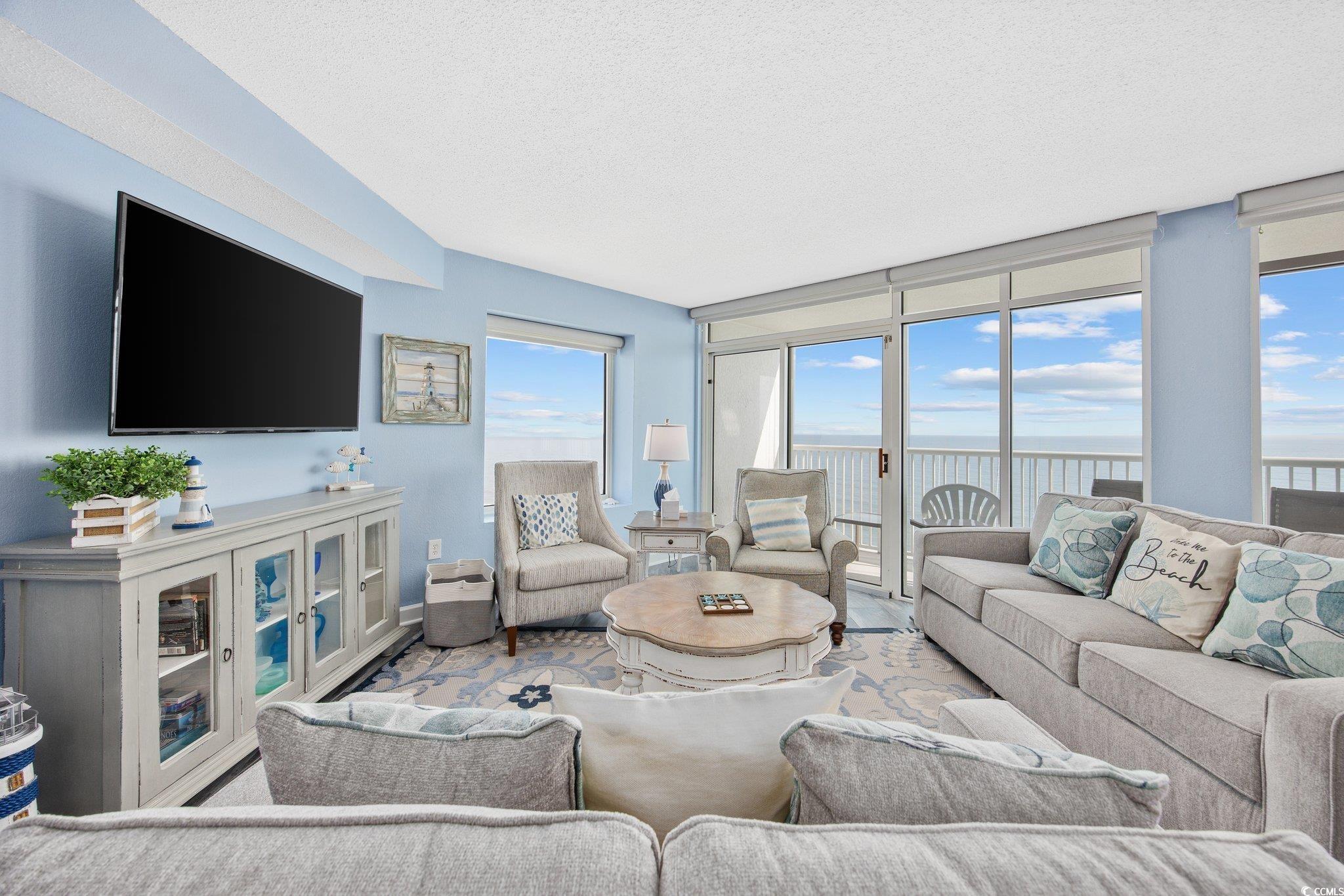 161 Seawatch Drive, Unit 1117 Myrtle Beach, SC 29572 - Photo 3 of 33 Living area featuring a water view, a textured cei