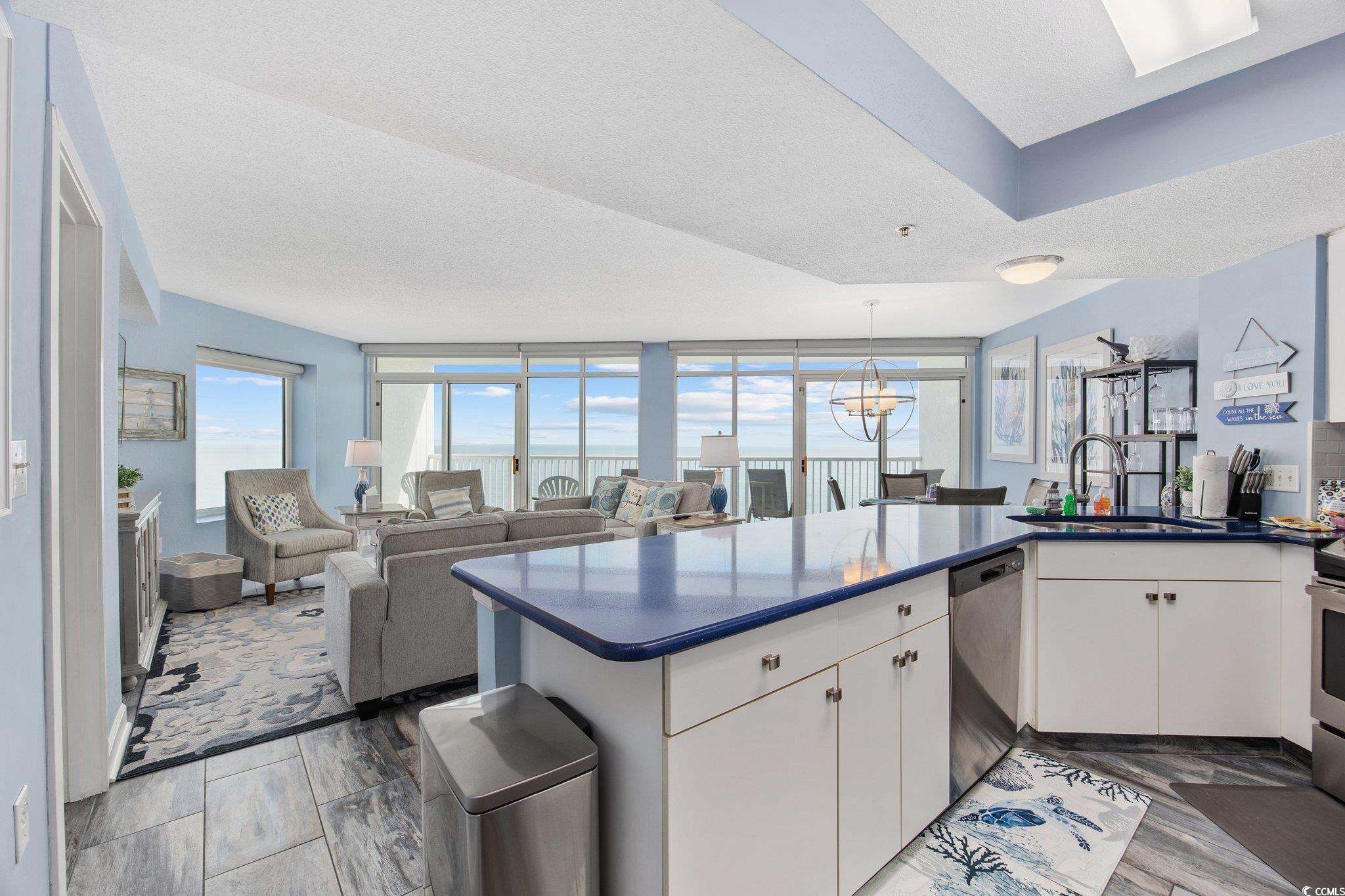 161 Seawatch Drive, Unit 1117 Myrtle Beach, SC 29572 - Photo 5 of 33 Kitchen featuring dark countertops, a peninsula, o