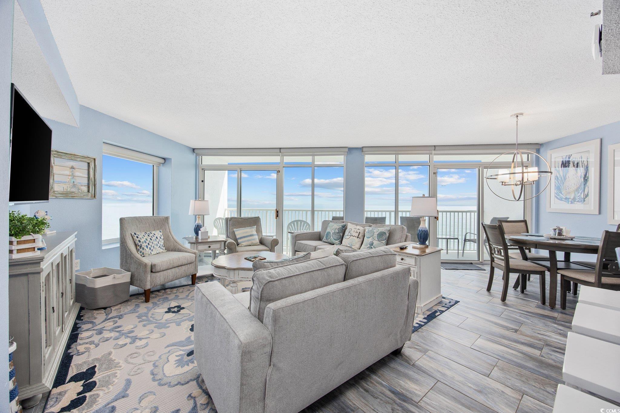 161 Seawatch Drive, Unit 1117 Myrtle Beach, SC 29572 - Photo 9 of 33 Living room featuring a textured ceiling, a wall o