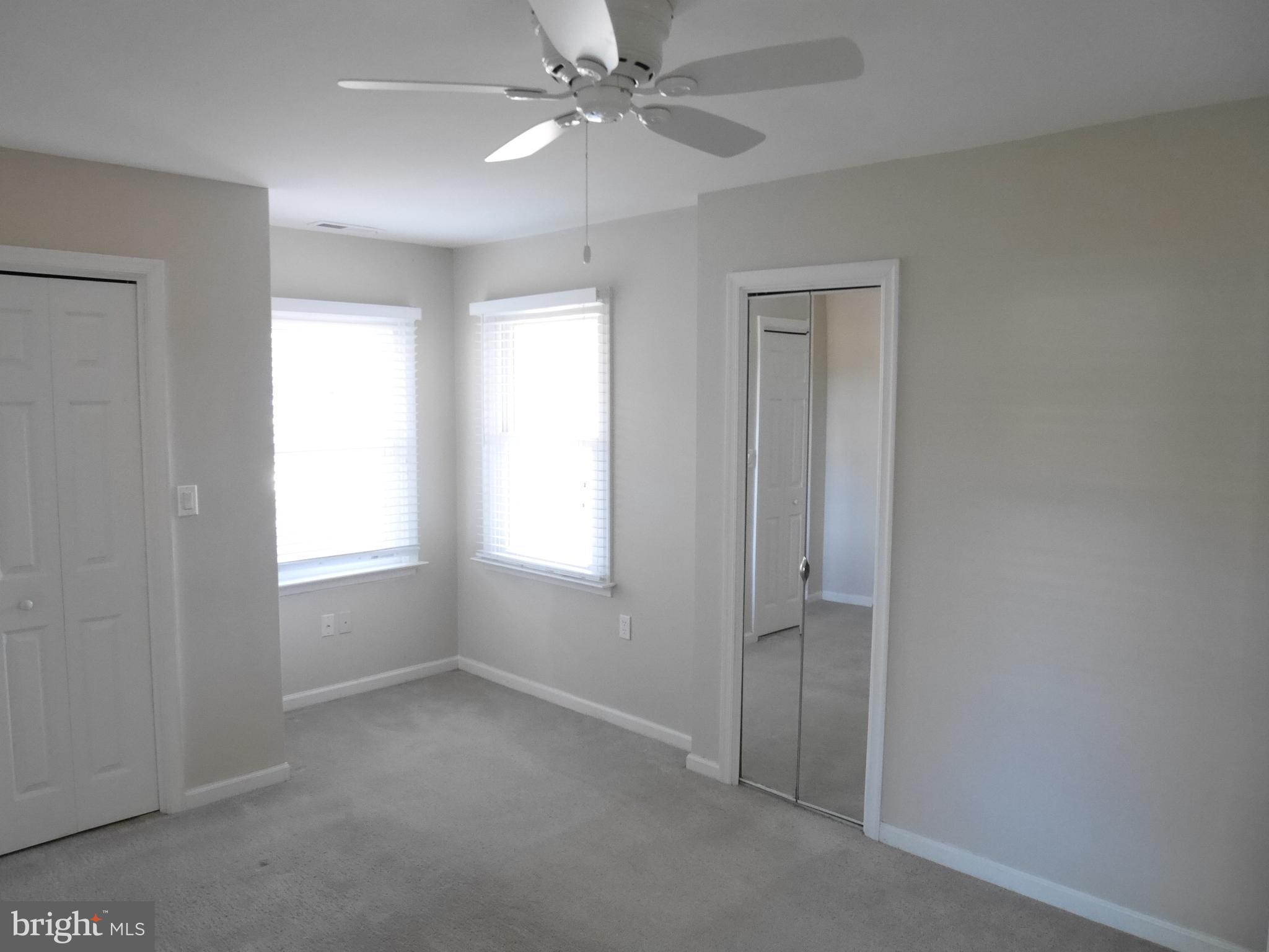 1705 Hambrooks Boulevard Cambridge, MD 21613 - Photo 11 of 22 an empty room with windows and fan