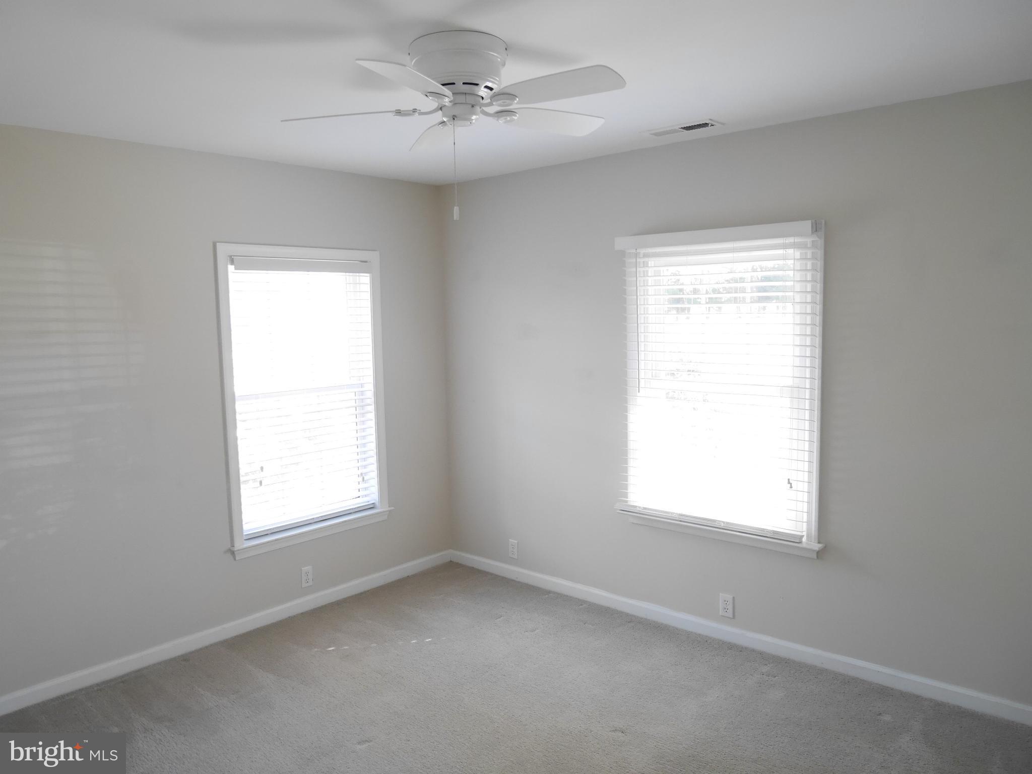 1705 Hambrooks Boulevard Cambridge, MD 21613 - Photo 14 of 22 an empty room with a window and a ceiling fan