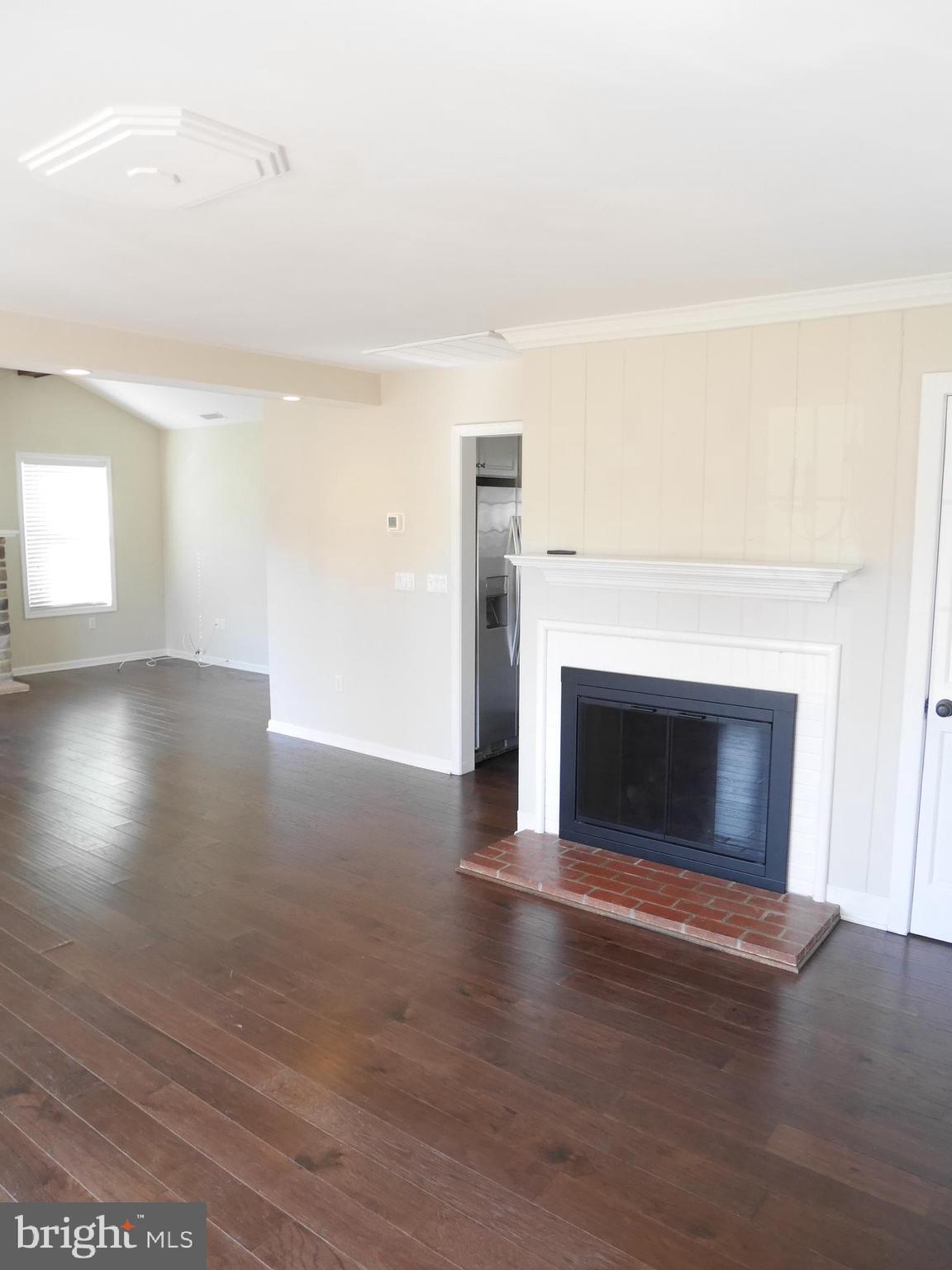 1705 Hambrooks Boulevard Cambridge, MD 21613 - Photo 5 of 22 a view of a livingroom with wooden floor and a fireplace