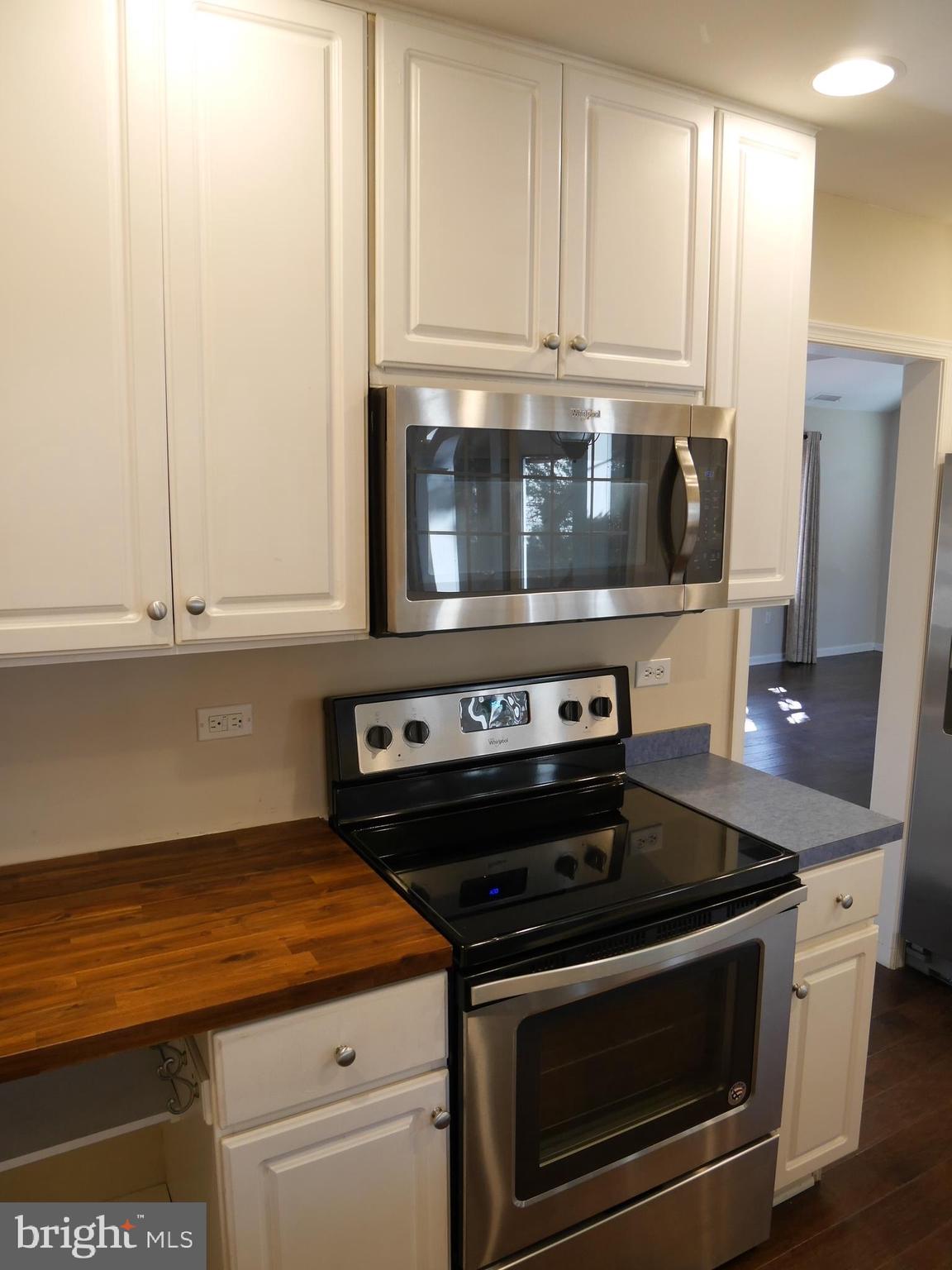 1705 Hambrooks Boulevard Cambridge, MD 21613 - Photo 7 of 22 a kitchen with granite countertop a stove microwave and cabinets