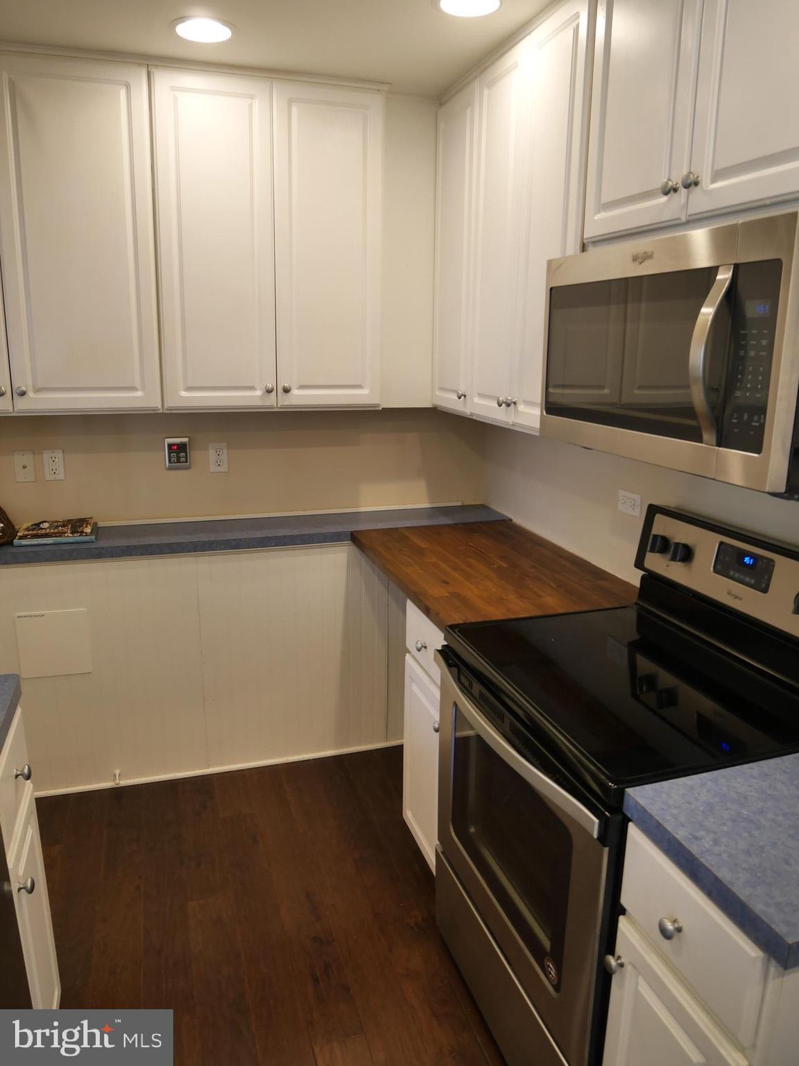 1705 Hambrooks Boulevard Cambridge, MD 21613 - Photo 9 of 22 a kitchen with granite countertop a stove and a microwave