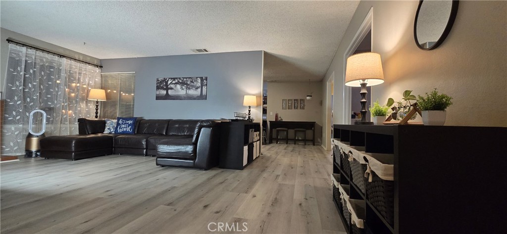 6830 Astoria Drive Riverside, CA 92503 - Photo 16 of 23 a living room with furniture a table and wooden floor
