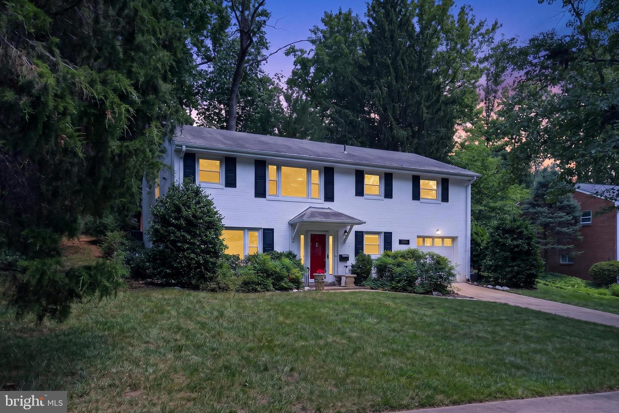 7604 Boulder Street Springfield, VA 22151 - Photo 11 of 39 a front view of a house with a yard and green space