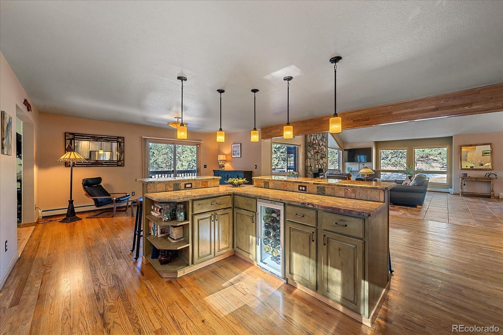 31196 Roberts Road Pine, CO 80470 - Photo 12 of 50 a open kitchen with stainless steel appliances granite countertop a stove and a wooden floors