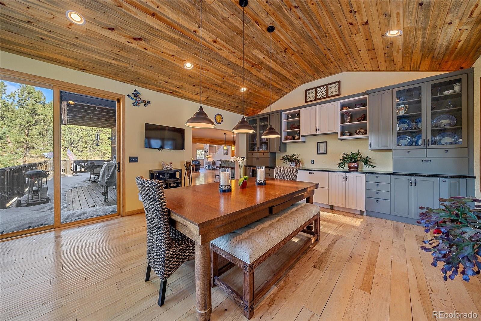 31196 Roberts Road Pine, CO 80470 - Photo 14 of 50 a outdoor dining space with furniture and wooden floor