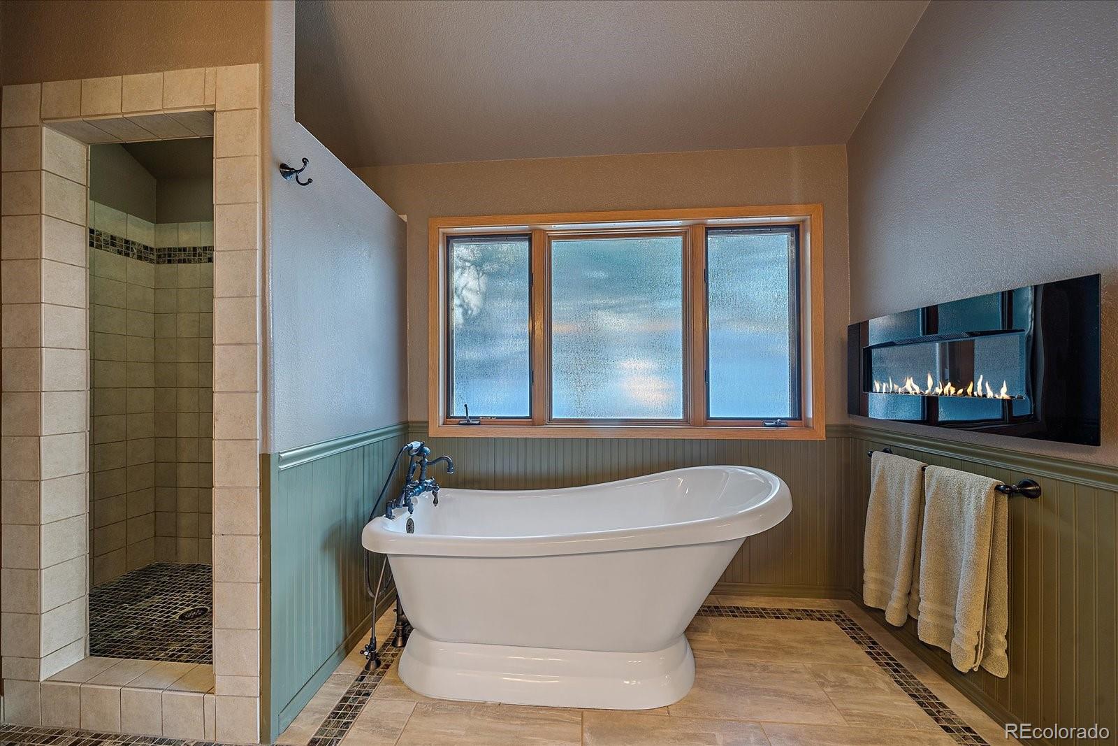 31196 Roberts Road Pine, CO 80470 - Photo 24 of 50 a bathroom with a tub and shower