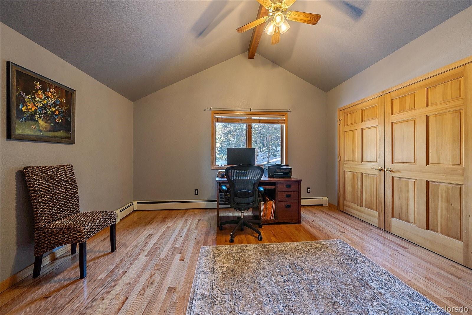 31196 Roberts Road Pine, CO 80470 - Photo 27 of 50 a living room with furniture and a wooden floor