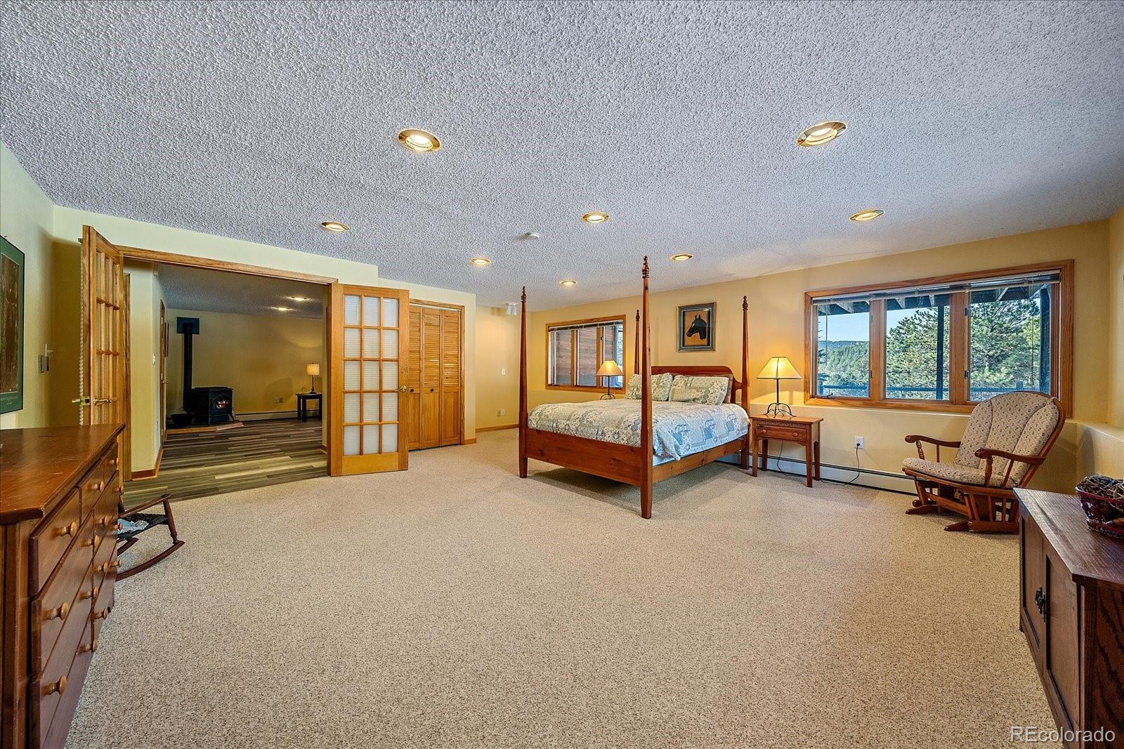 31196 Roberts Road Pine, CO 80470 - Photo 30 of 50 a bedroom with furniture and a large window