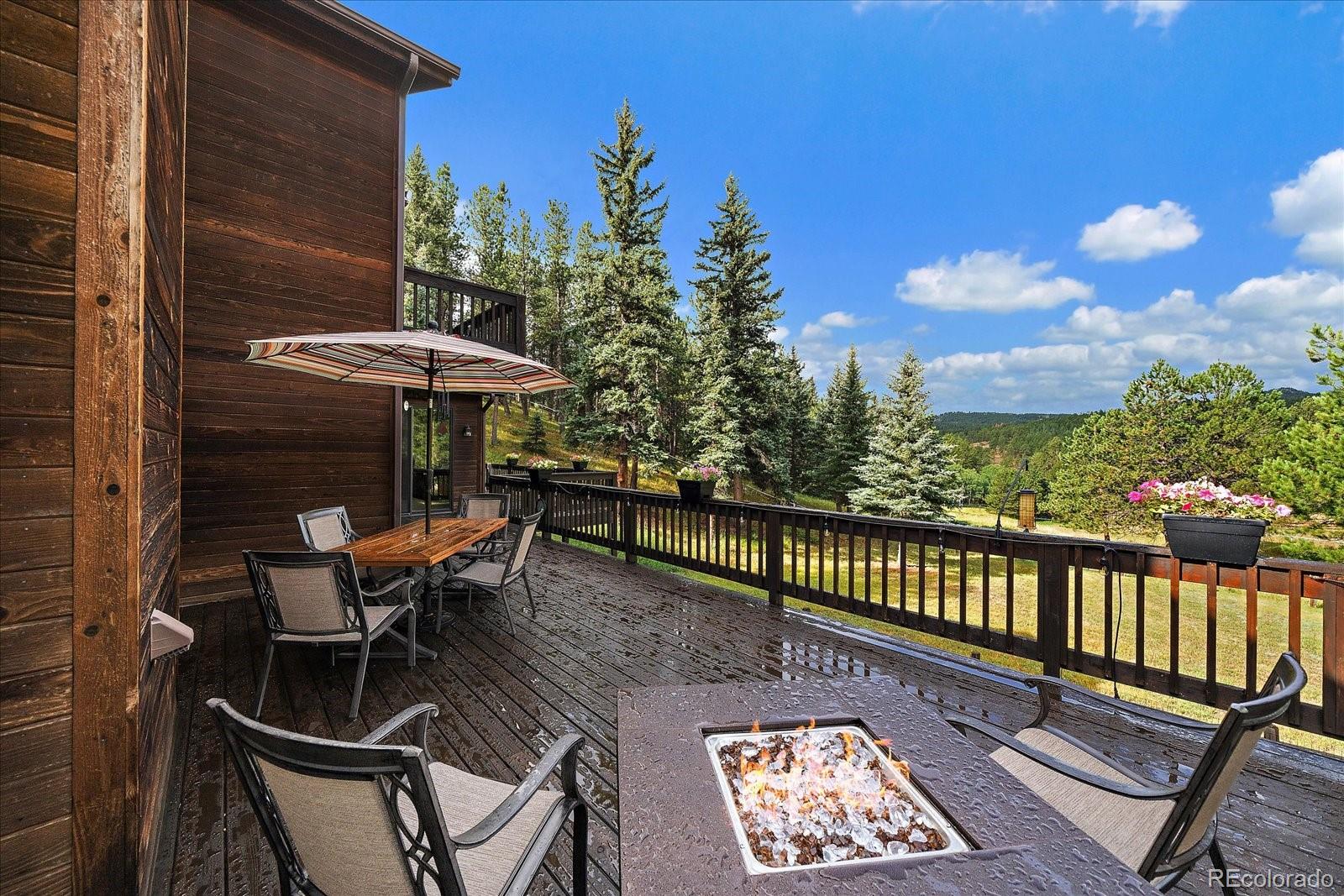 31196 Roberts Road Pine, CO 80470 - Photo 35 of 50 a view of a patio with a table