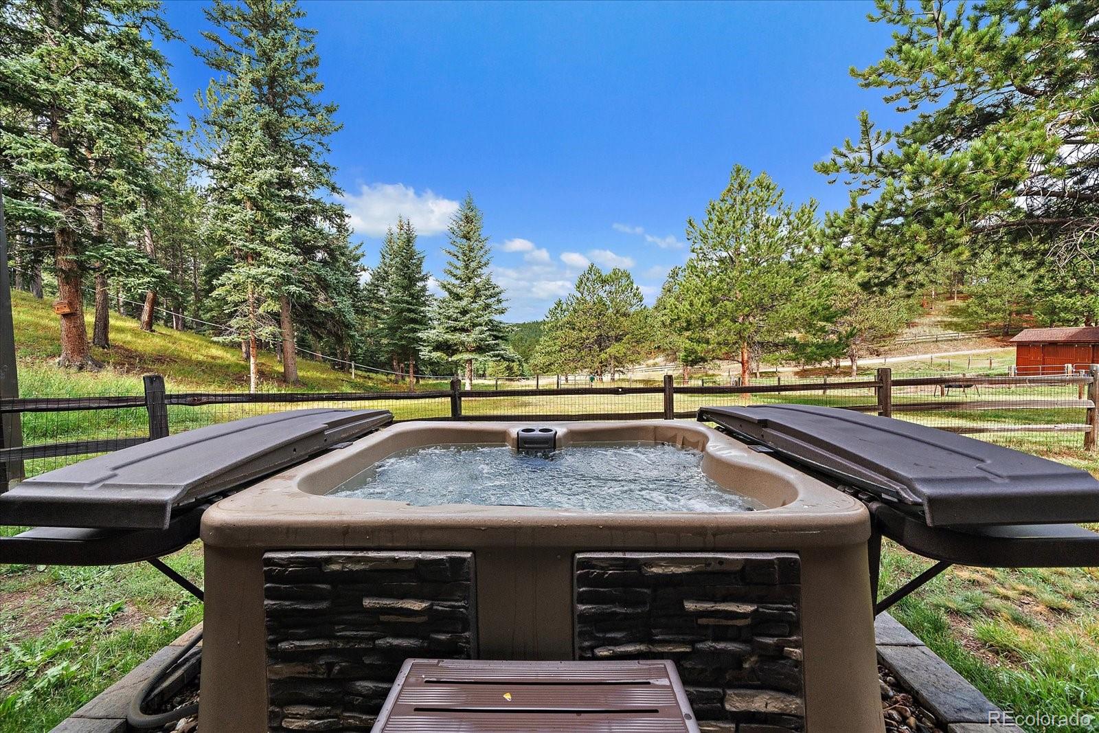 31196 Roberts Road Pine, CO 80470 - Photo 40 of 50 a view of a balcony with two chairs and a table