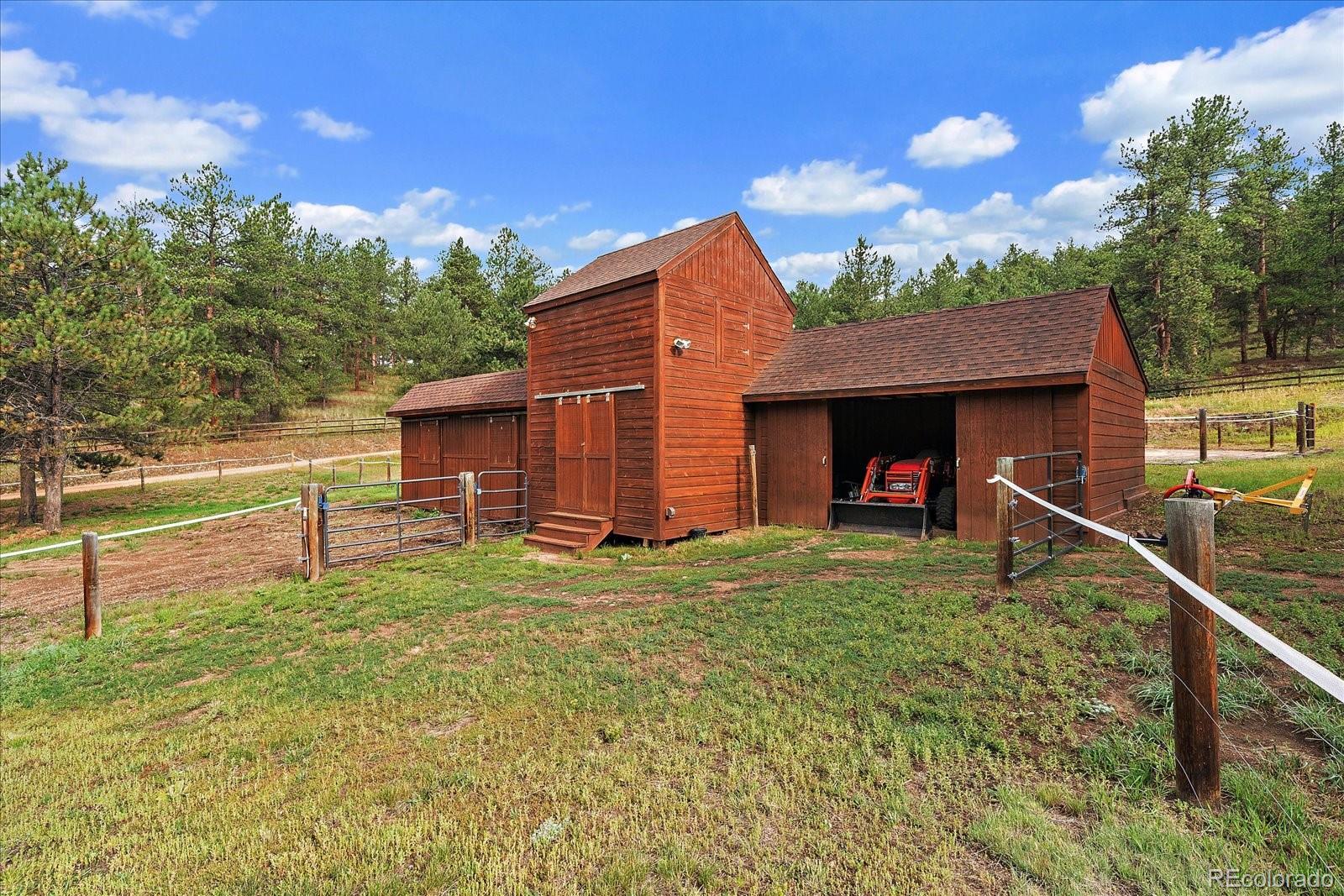 31196 Roberts Road Pine, CO 80470 - Photo 45 of 50 a view of a house with backyard and porch