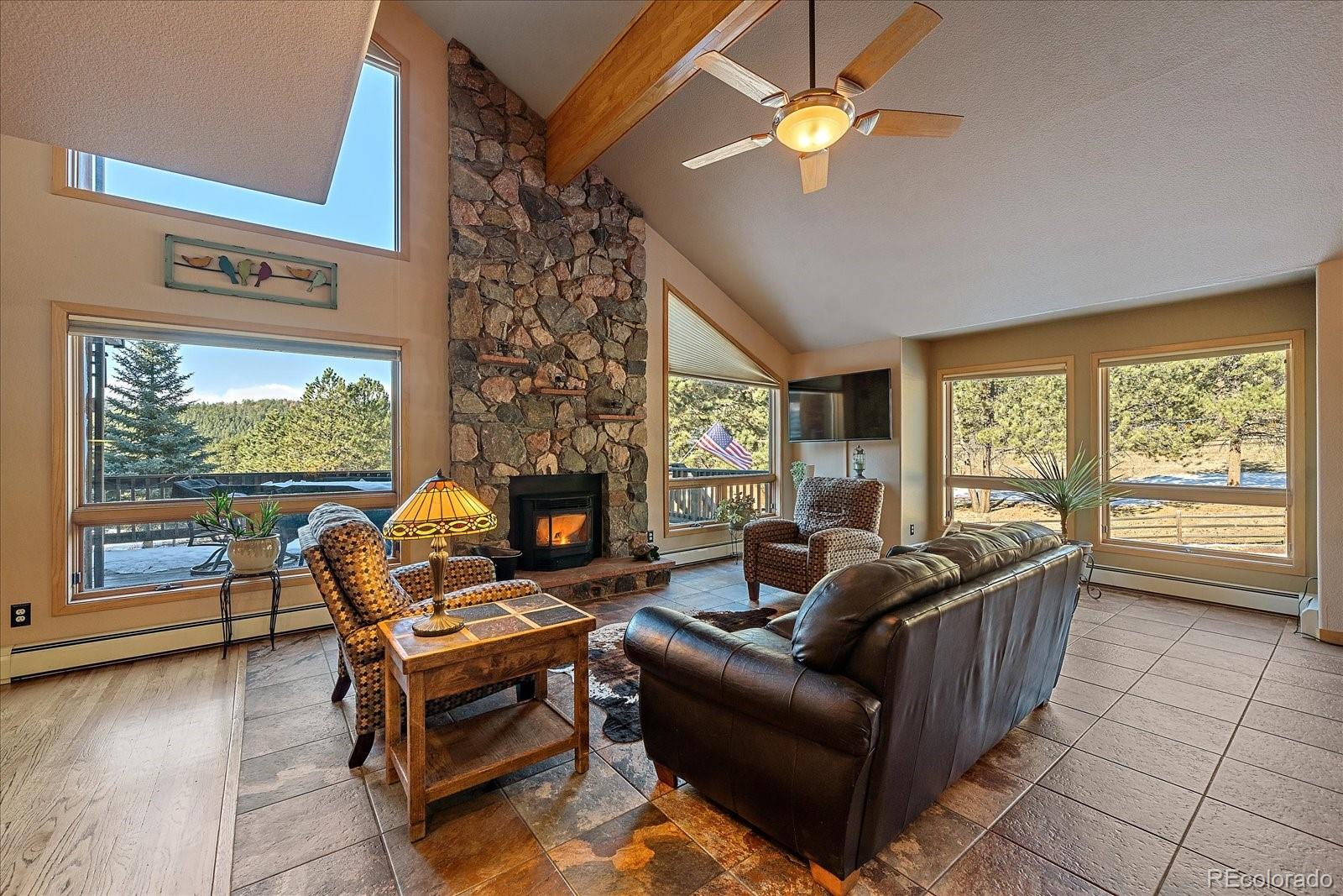 31196 Roberts Road Pine, CO 80470 - Photo 6 of 50 a living room with furniture and a fireplace